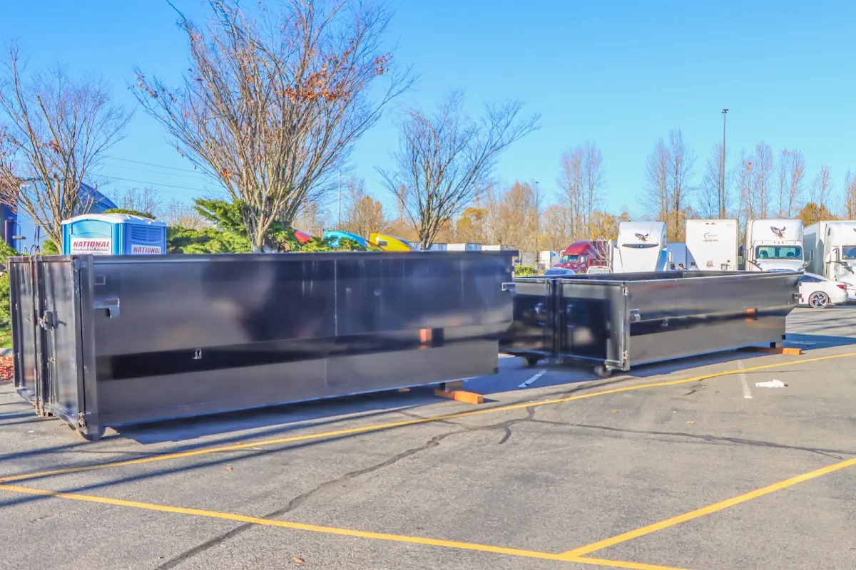 Professional dumpster rental service with roll-off container on residential driveway in Sunnyside